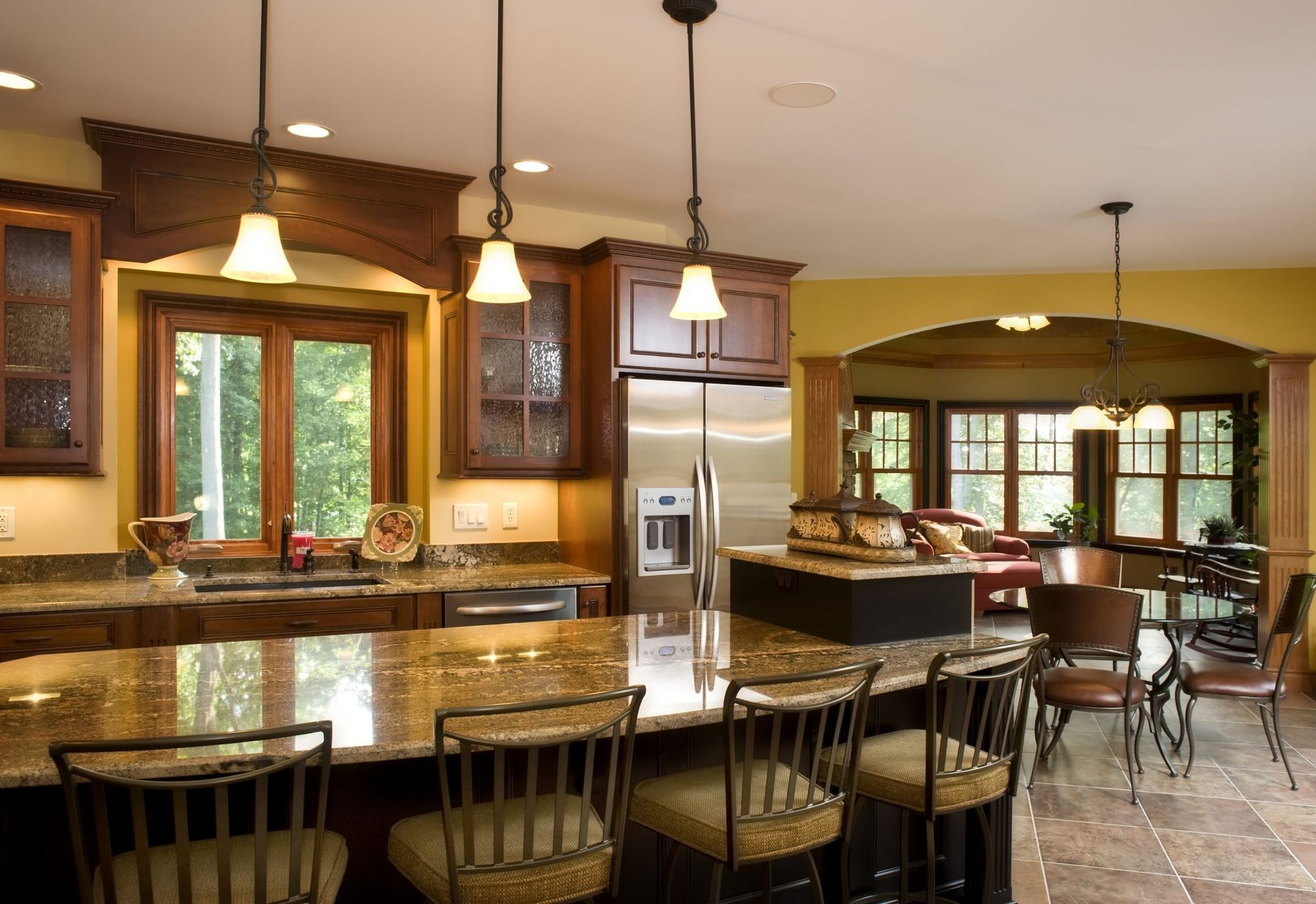 A kitchen with granite counter tops and stainless steel appliances.