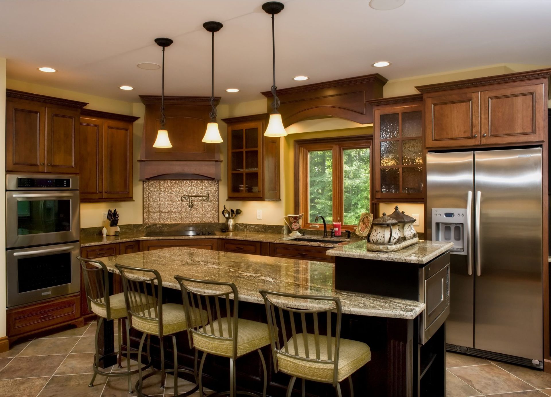 A kitchen with stainless steel appliances and granite counter tops.