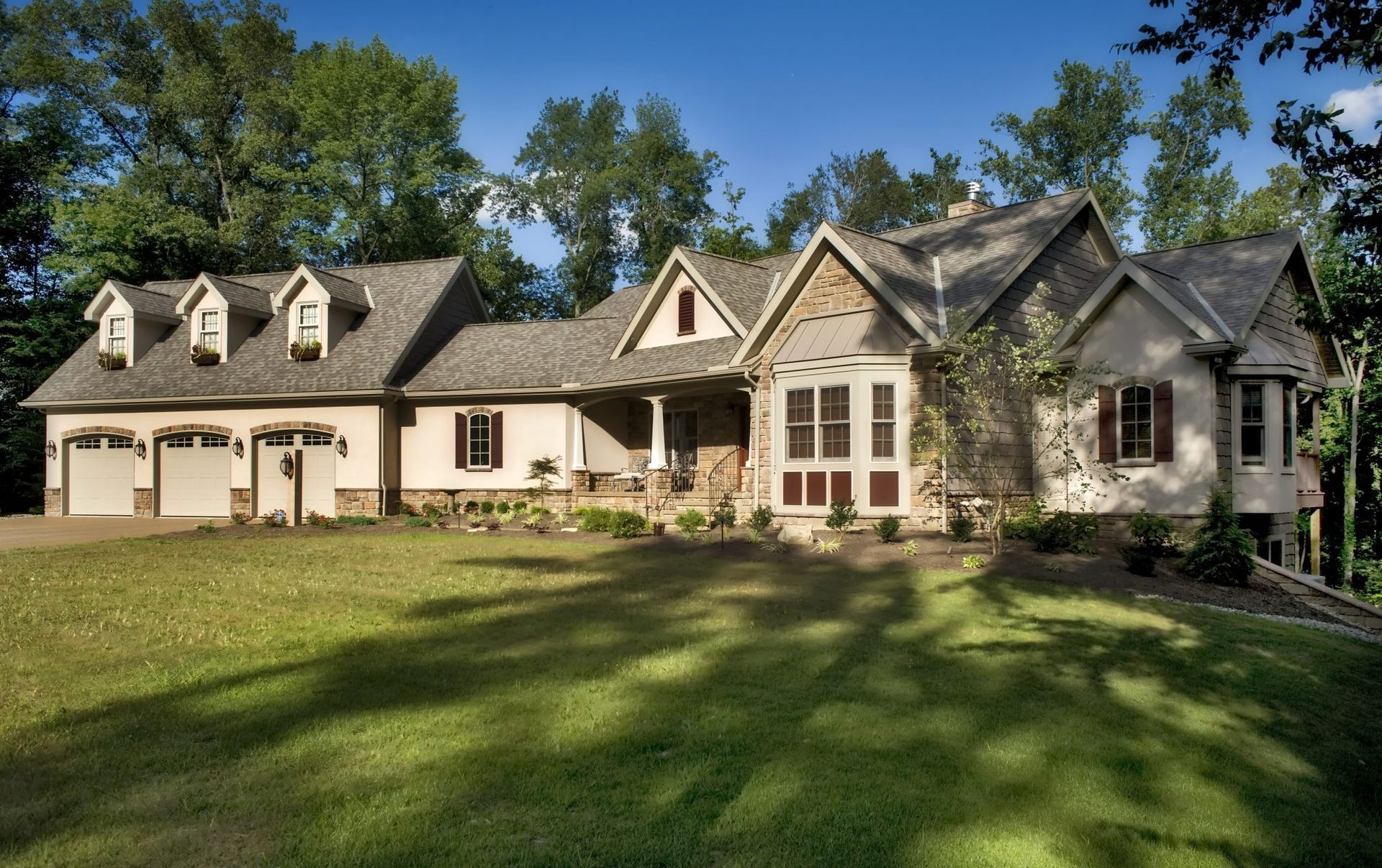 A large house with a large lawn in front of it.