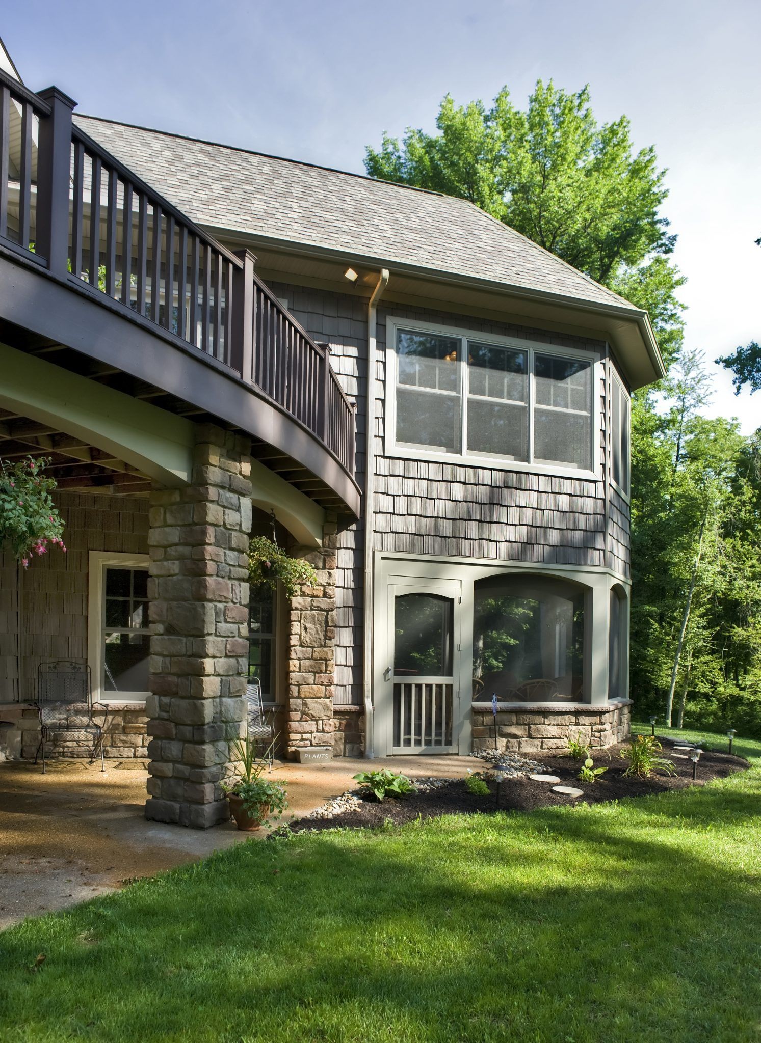 A house with a balcony and a lot of windows.