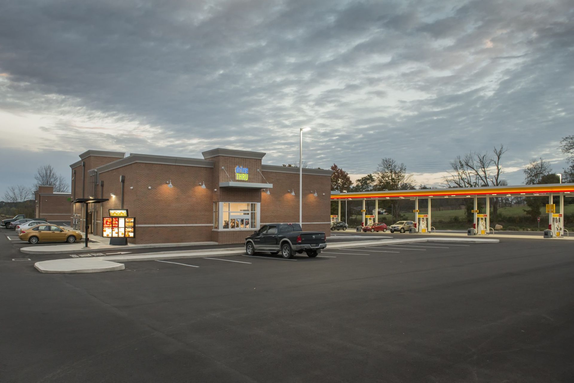 A car is parked in front of a gas station.