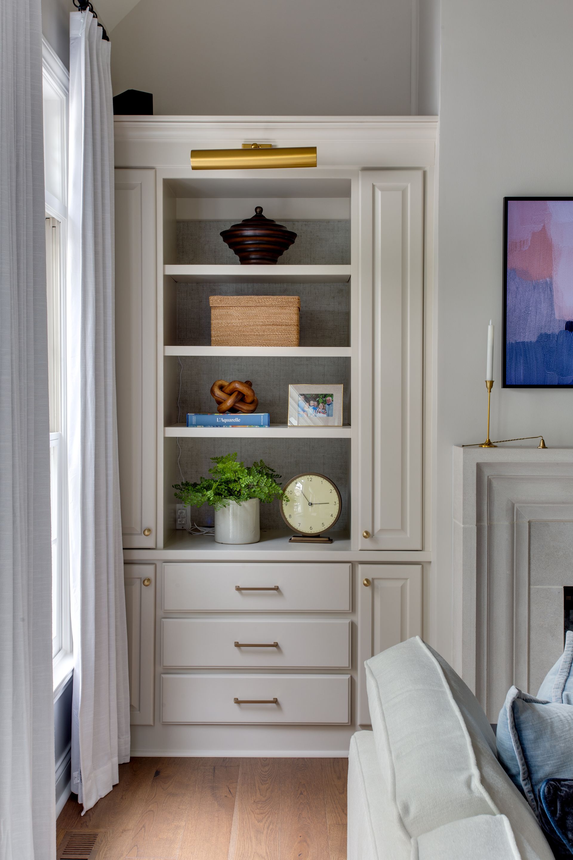 A living room with a bookshelf and a fireplace.