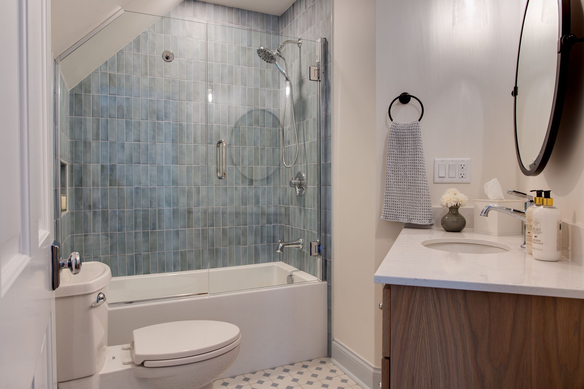 A bathroom with a toilet, sink, bathtub and shower.