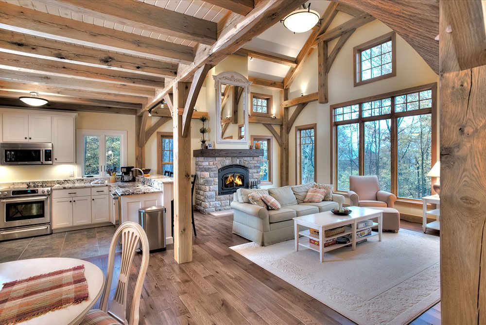 A living room with a couch , table , chairs and a fireplace.