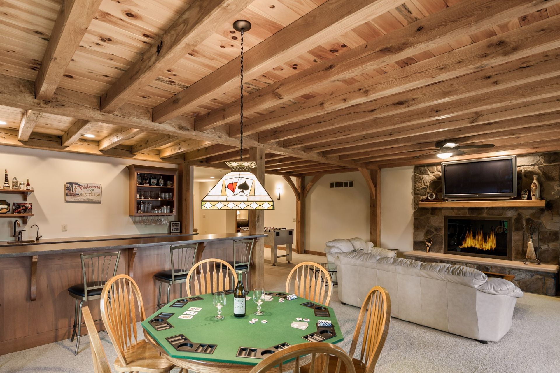 A living room with a poker table and chairs