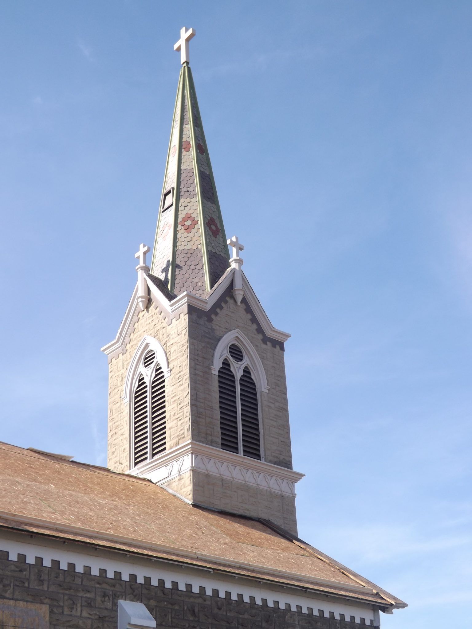 A church steeple with a cross on top of it.
