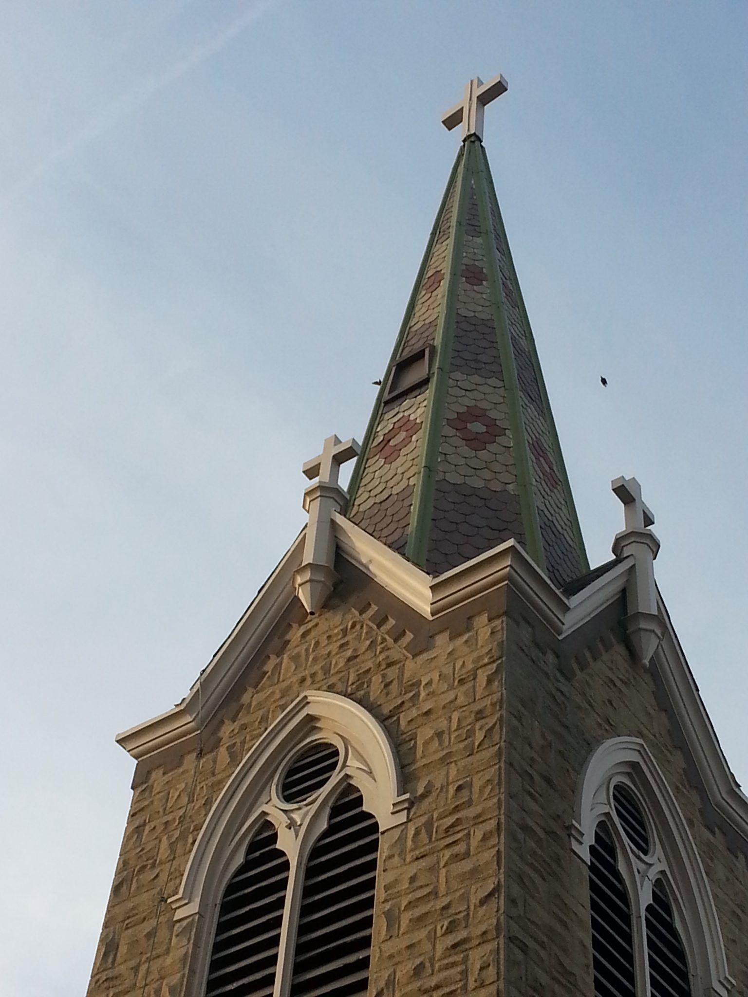 A church tower with a cross on top of it.