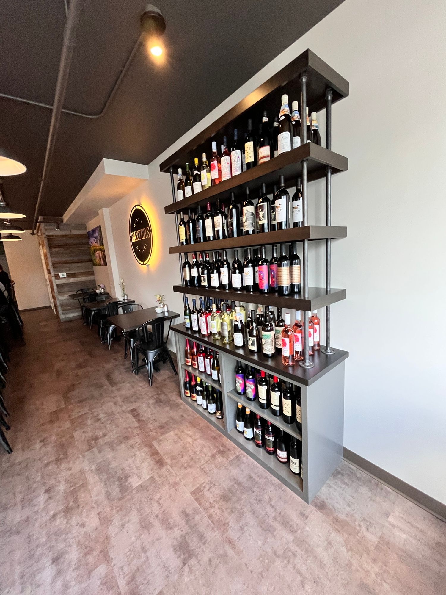 There are many bottles of wine on the shelves in this room.