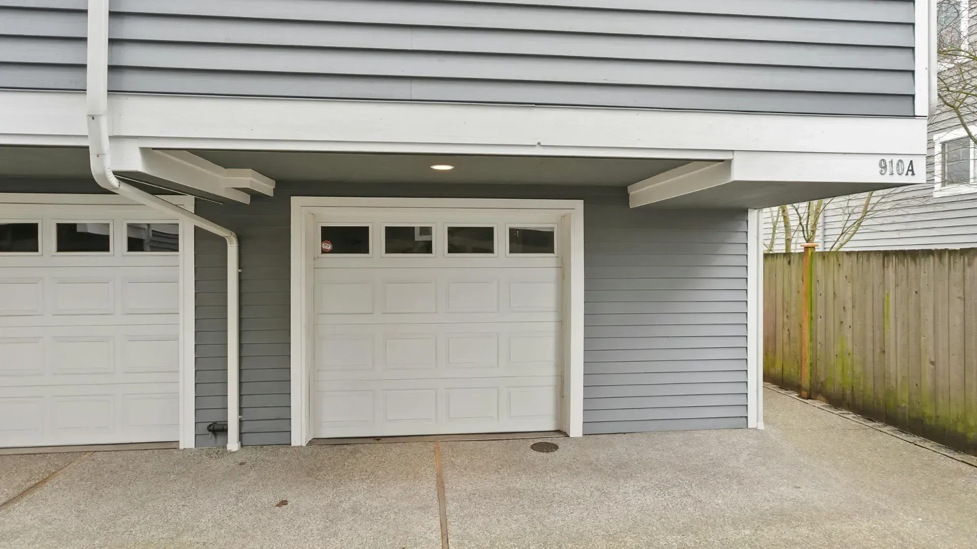 A white garage door is on the side of a house