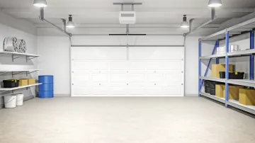 An empty garage with a white garage door and shelves.