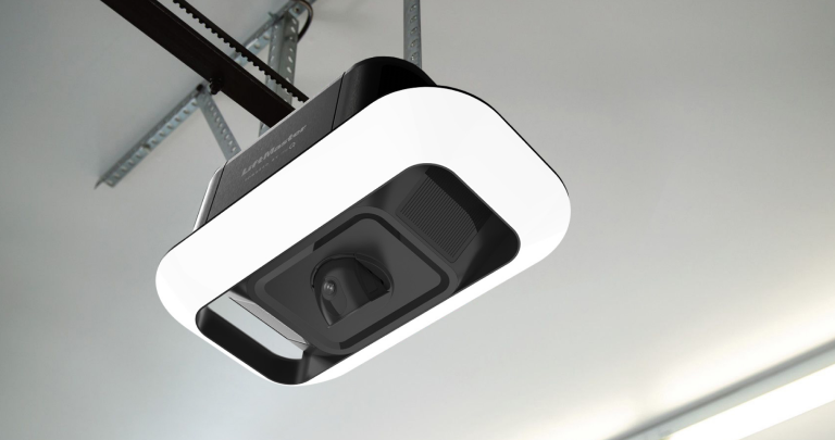 A garage door opener is hanging from the ceiling in a garage.