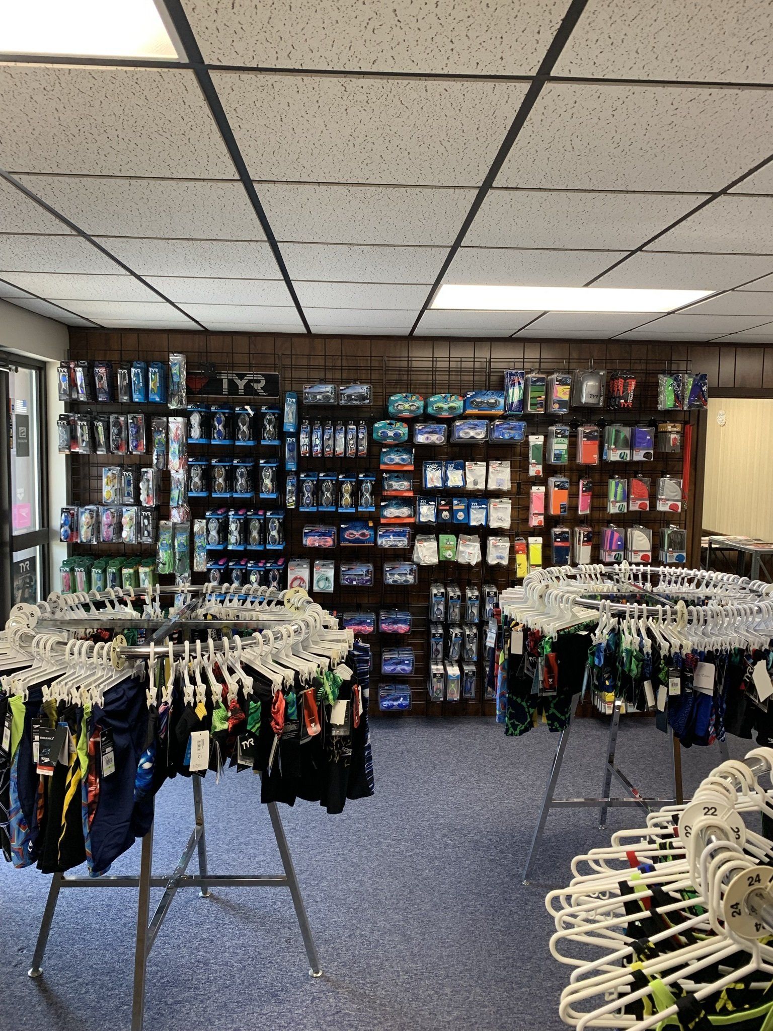 A store filled with lots of clothes hanging on racks.