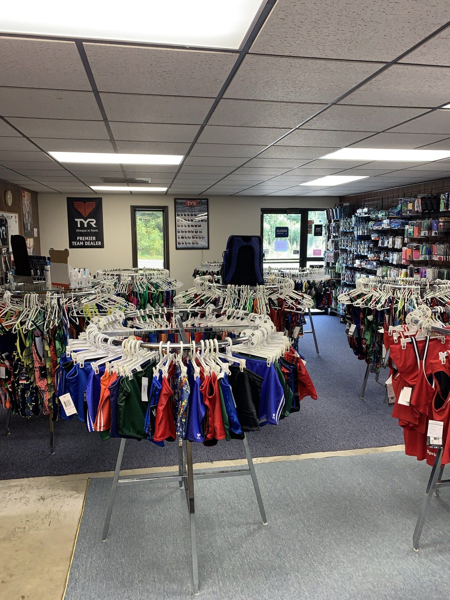 A store filled with lots of clothes hanging on racks.
