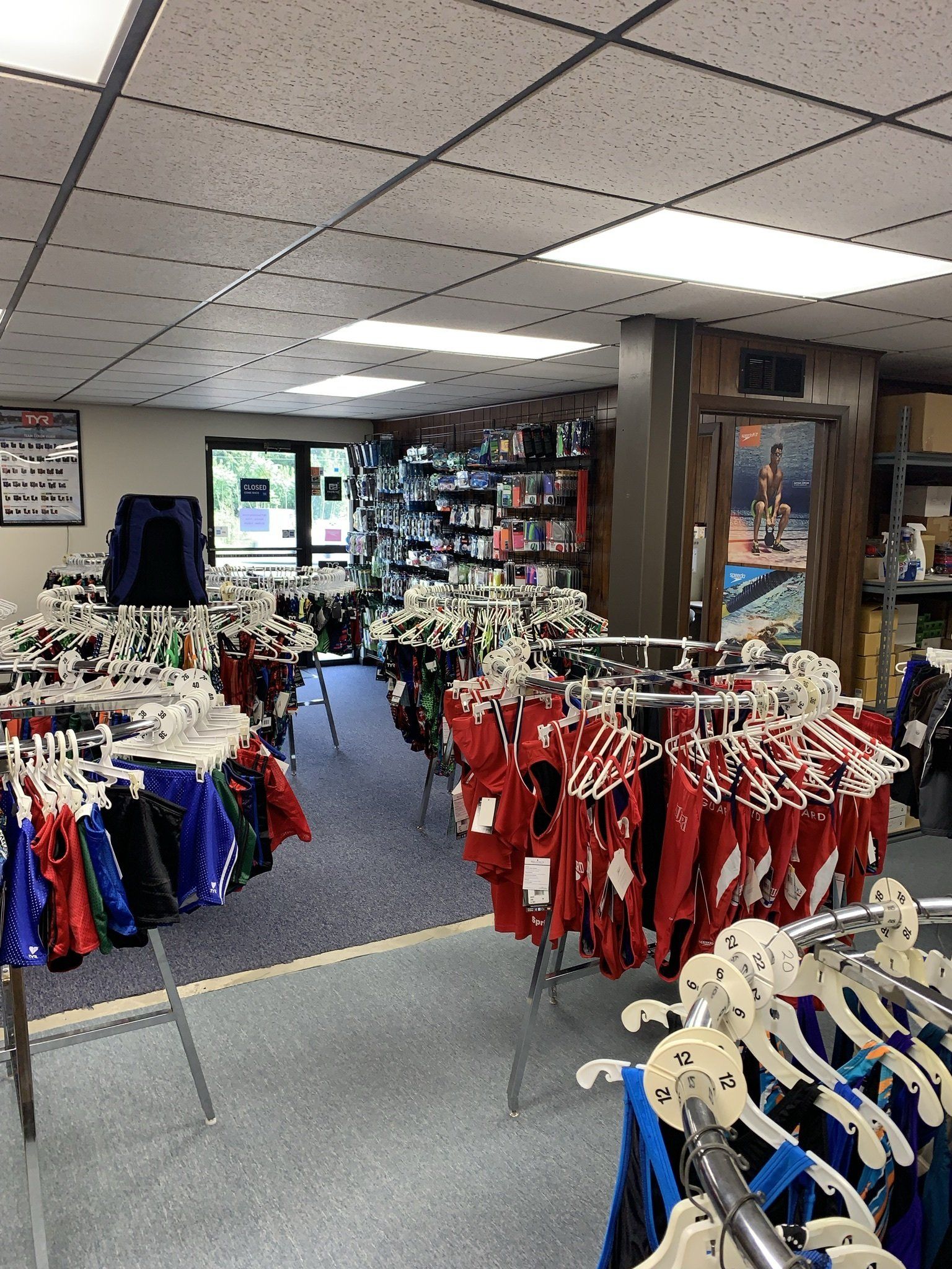 A store filled with lots of clothes hanging on racks.
