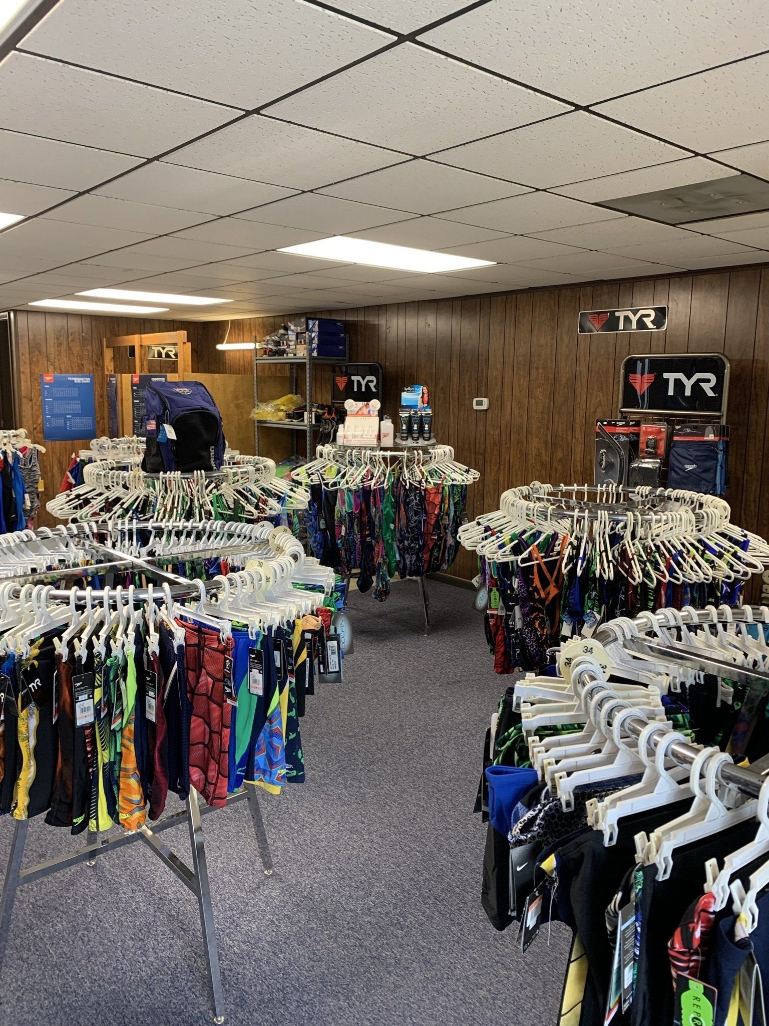 A store filled with lots of clothes hanging on racks.