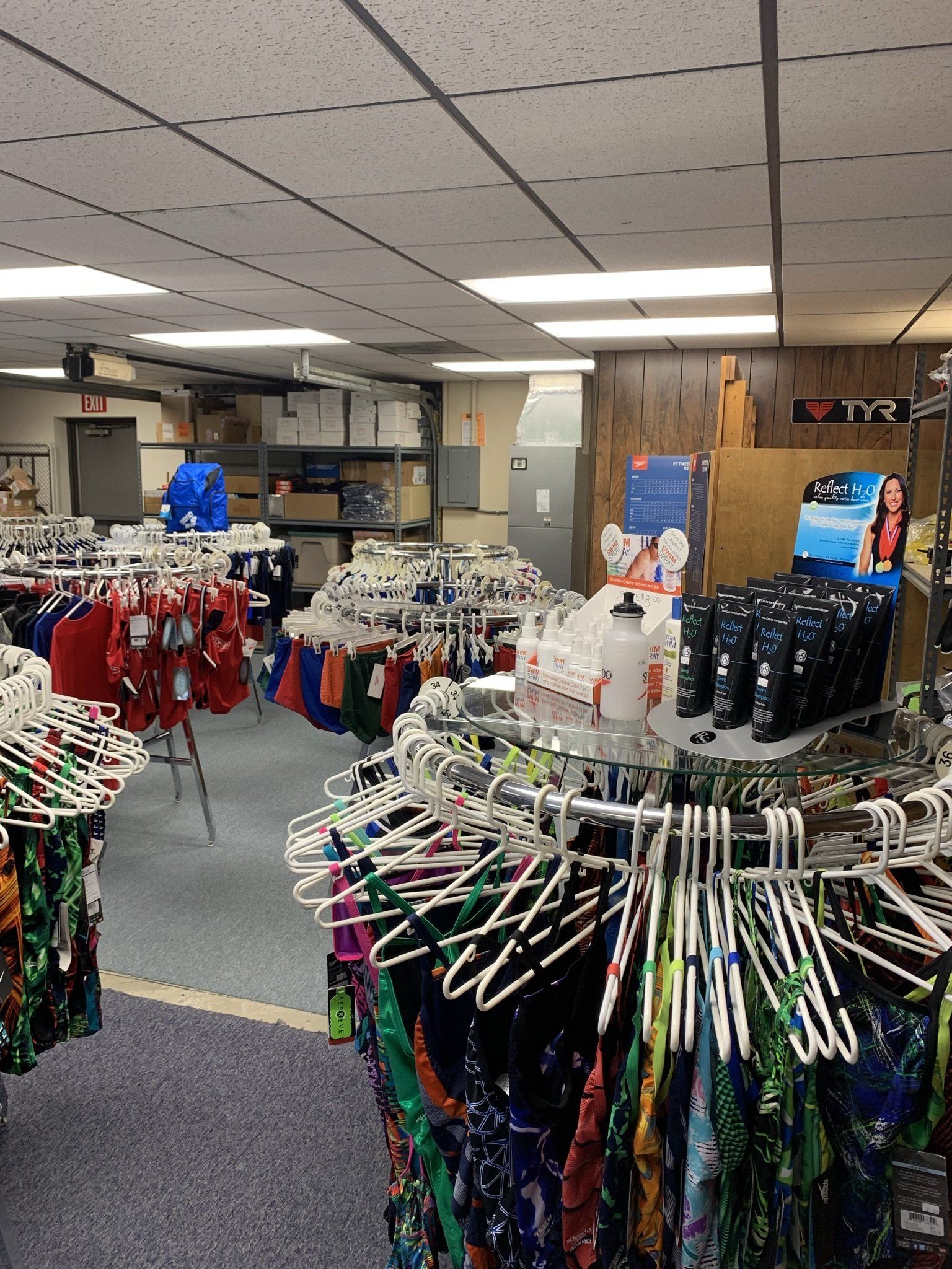 A store filled with lots of clothes hanging on racks
