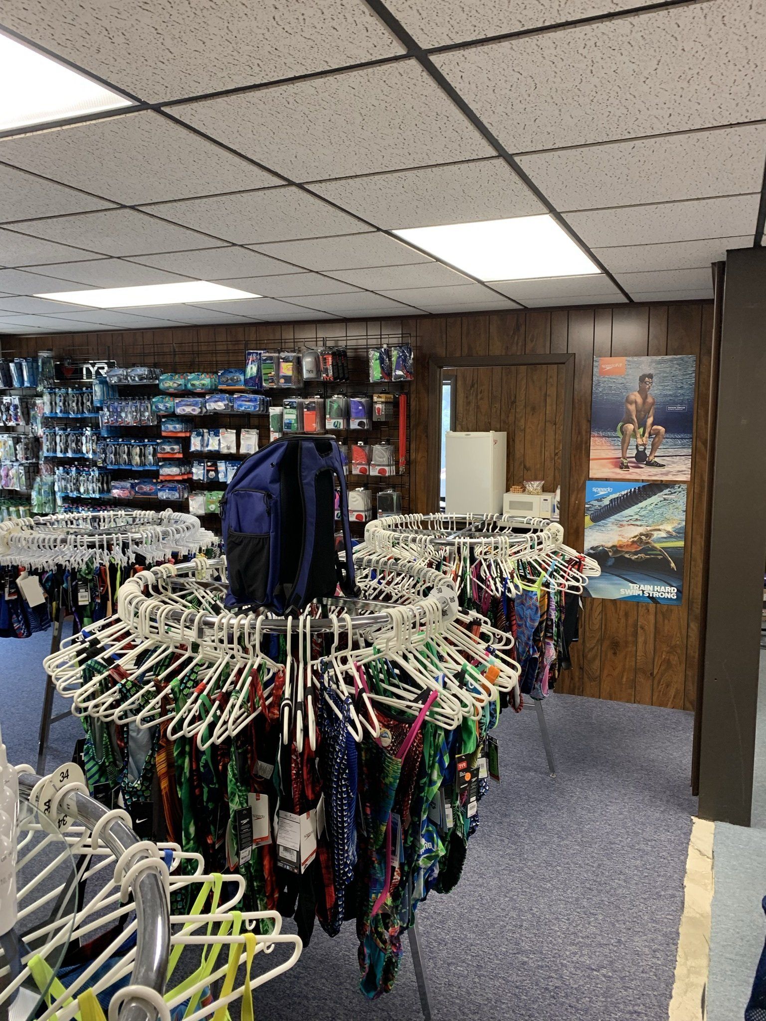 A store filled with lots of clothes hanging on racks.