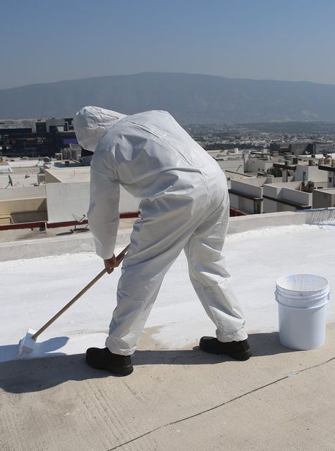 Worker Coating The Flat Roof