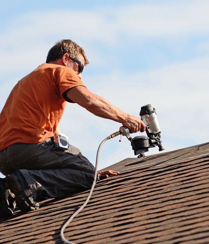 Man Installing Shingles Roof Tiles