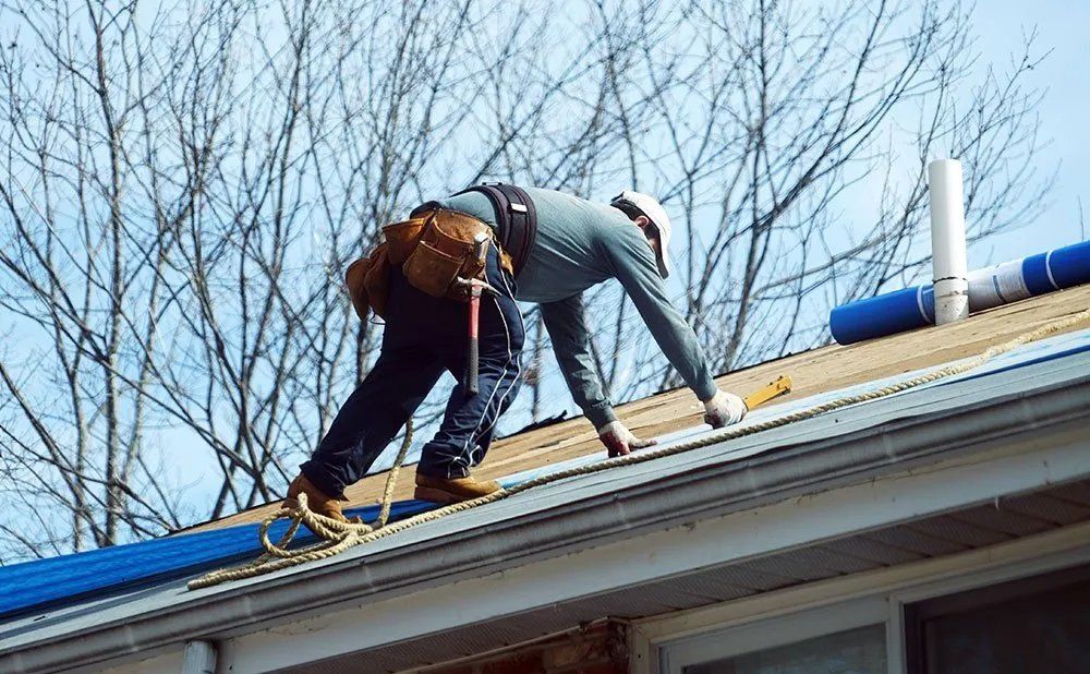 Worker On Top Of The Roof