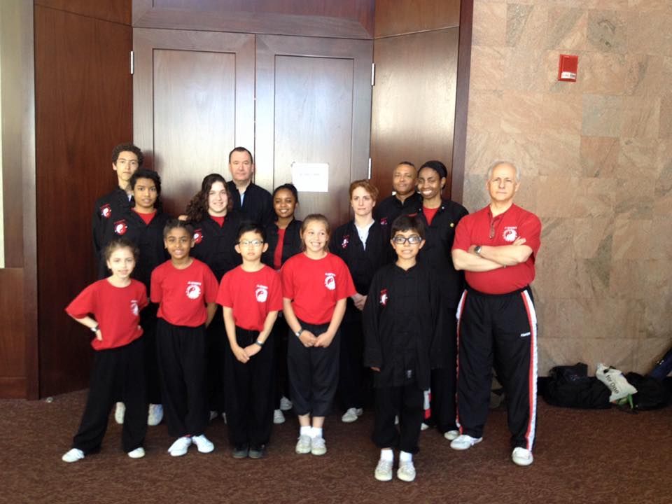 A group of people wearing red shirts with the letter a on them