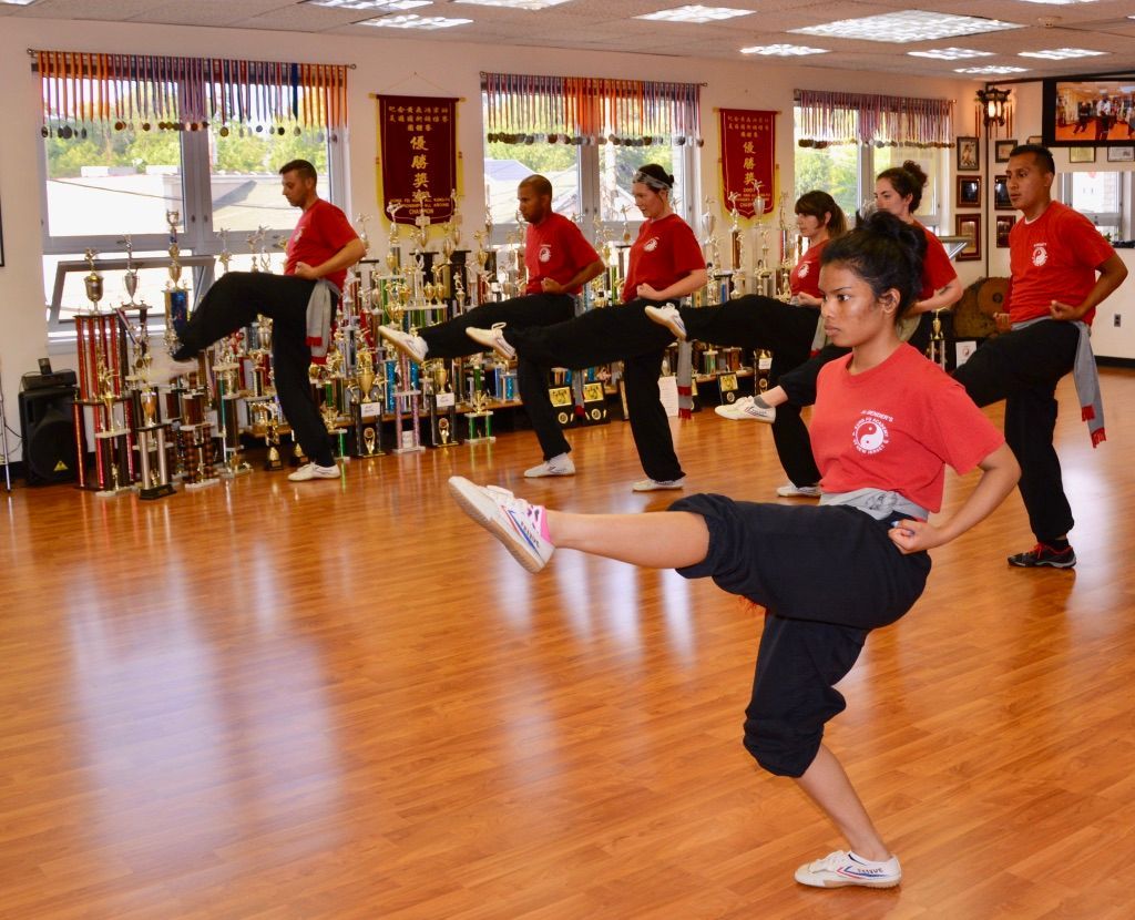A group of people are practicing martial arts in a gym