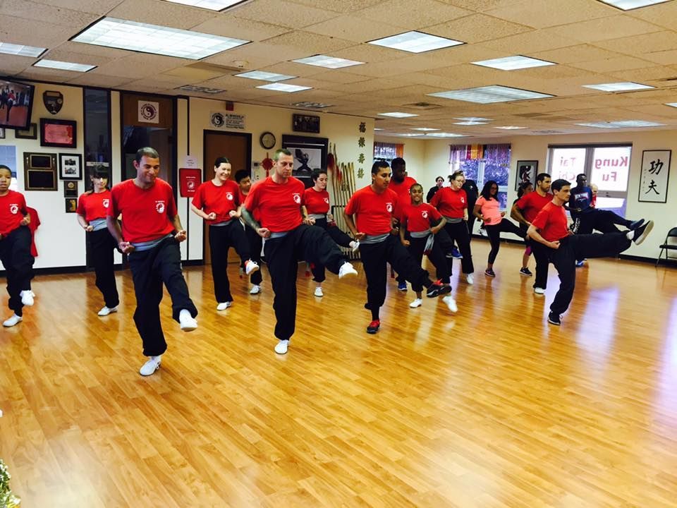 A group of people are practicing martial arts in a gym