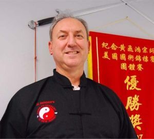 A man wearing a black shirt with a chinese symbol on it