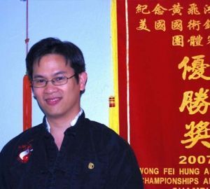 A man stands in front of a sign that says 2007