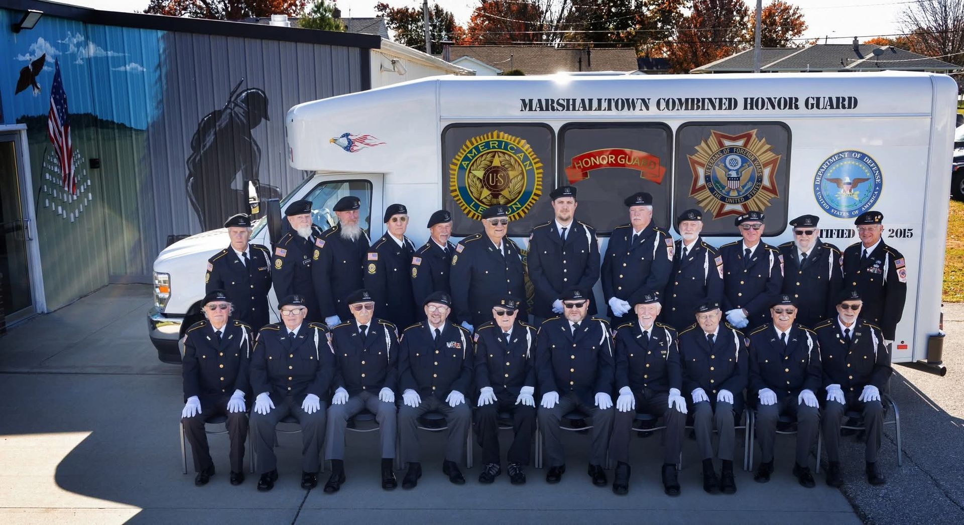 A bunch of white roses are laying on top of an american flag.
