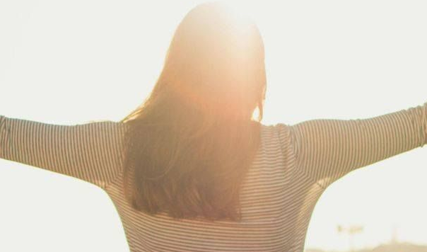 rear vision of woman with arms out