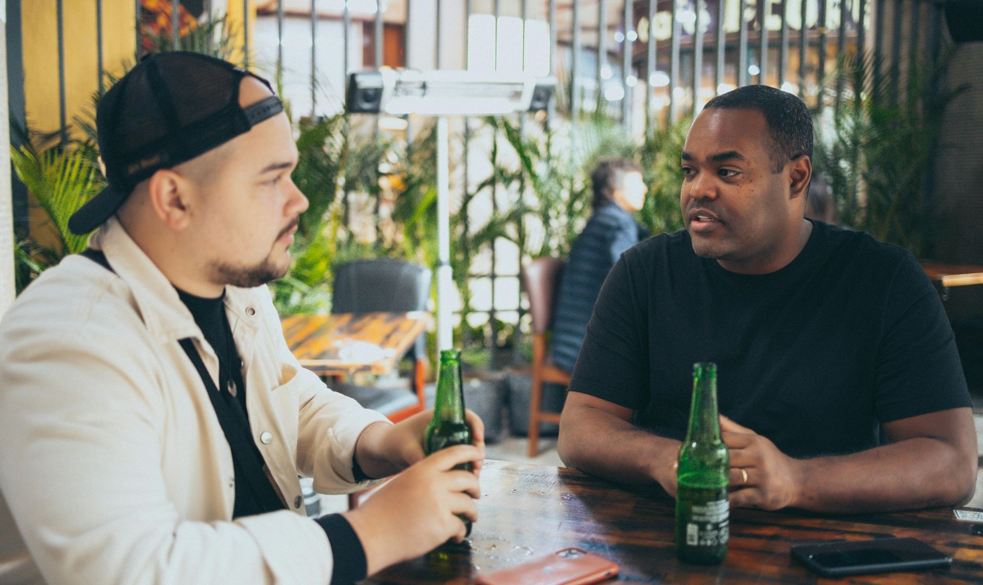 2 men drinking beer and talking