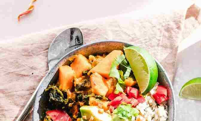 woman at laptop holding head in hands