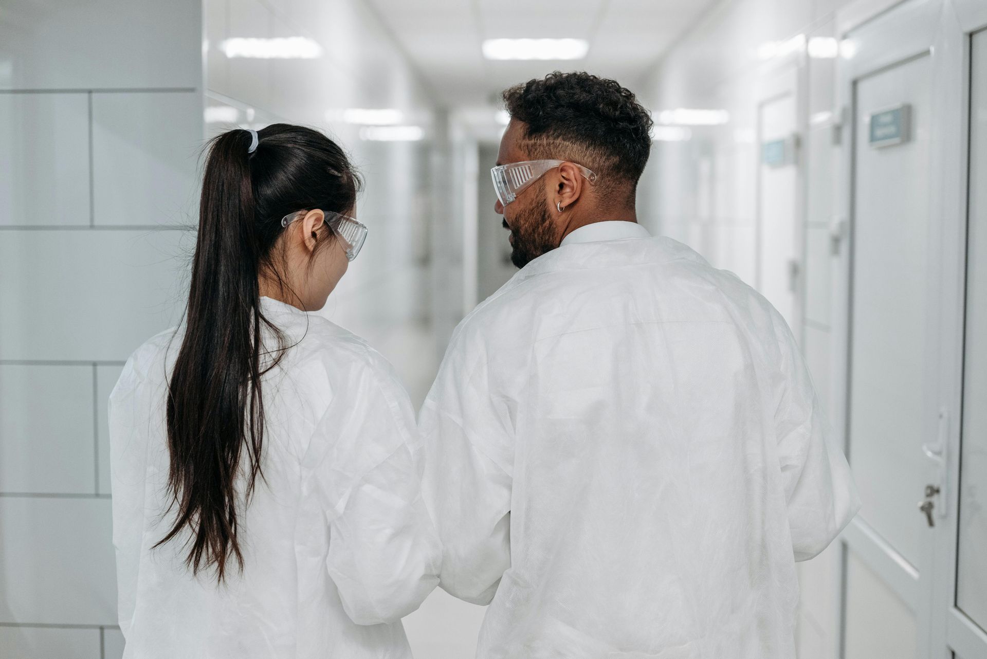 2 scientists walking with back to the camera