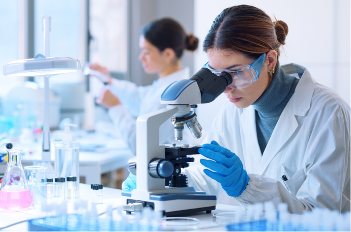 Scientist looking through microscope