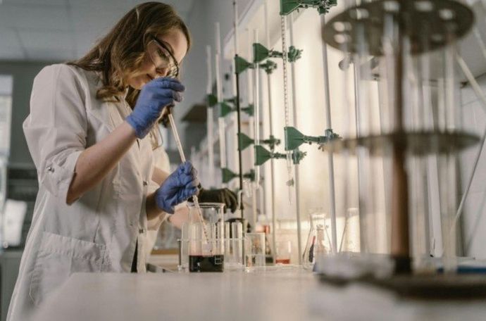 Woman putting eye drops in