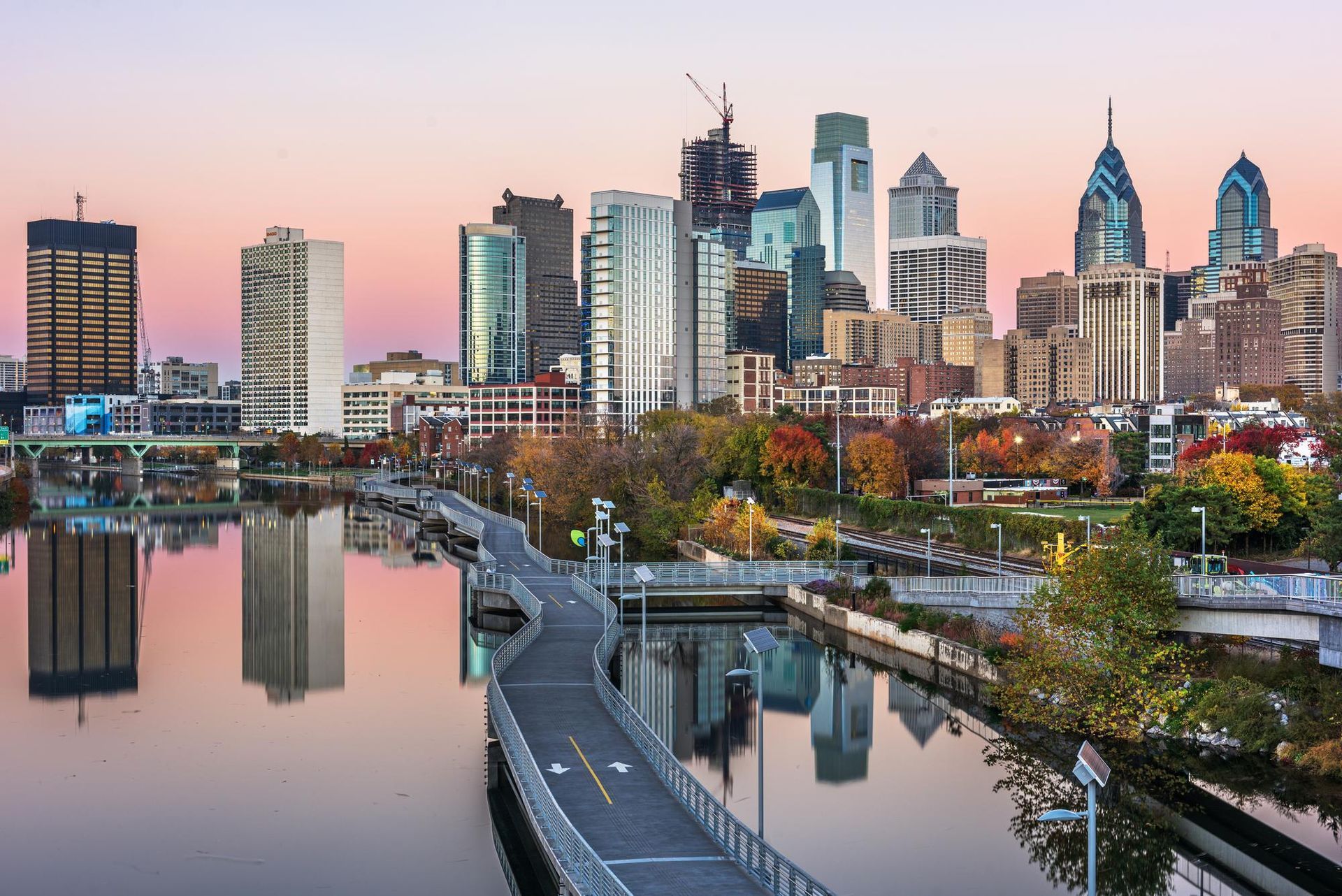 A city skyline is reflected in a body of water.