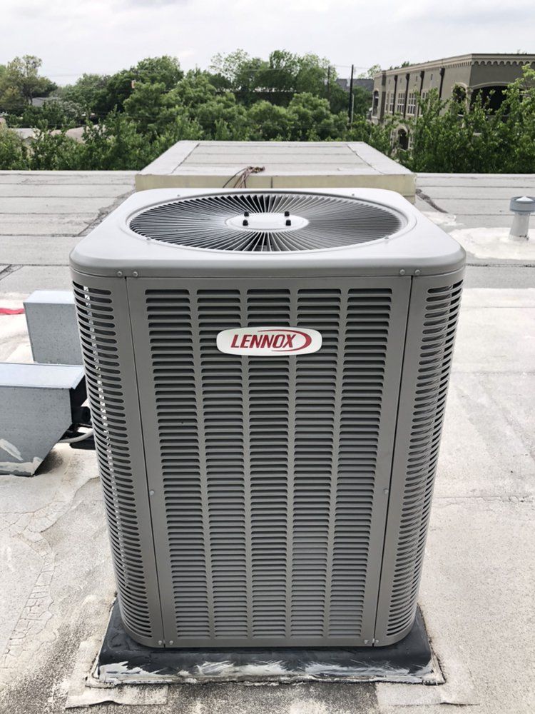 A lennox air conditioner is sitting on top of a roof.