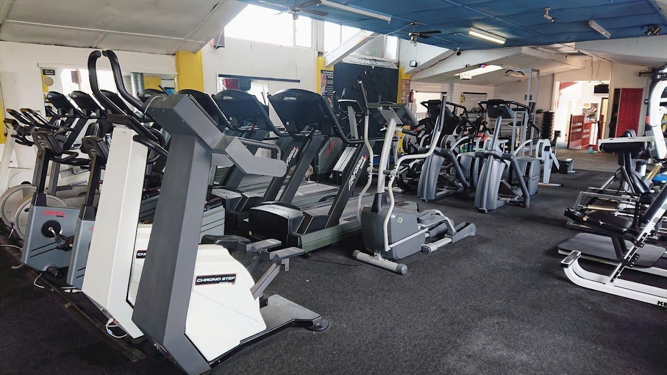A gym filled with lots of exercise equipment.