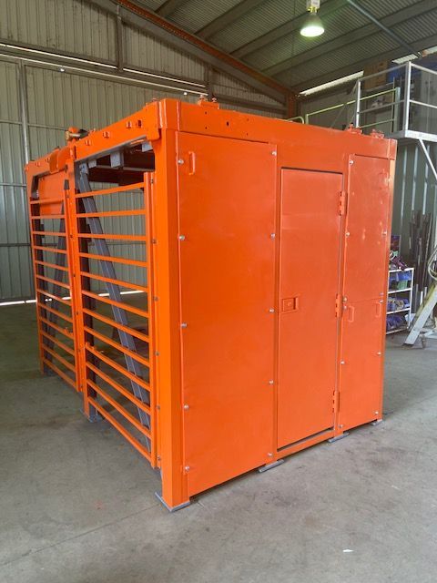 A Large Orange Building With A Door And Stairs — ADR Engineering in Collinsville, QLD