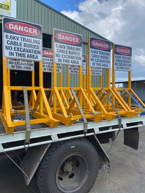A Row Of Yellow Danger Signs On The Back Of A Truck — ADR Engineering in Collinsville, QLD
