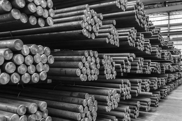 Bunch of Metal Rods Are Stacked on Top of Each Other in a Warehouse — ADR Engineering in Collinsville, QLD