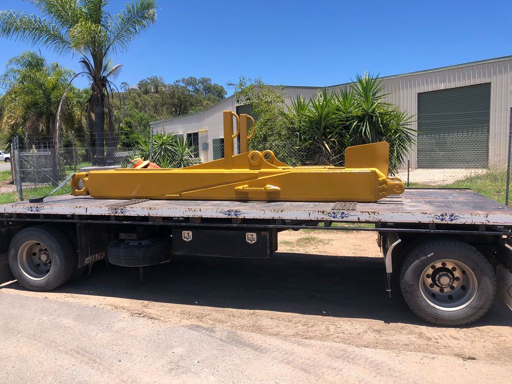 A Large Yellow Object Is Sitting On Top Of A Flatbed Truck — ADR Engineering in Collinsville, QLD