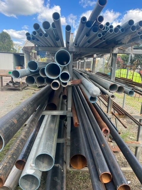 A Bunch Of Metal Pipes Are Stacked On Top Of Each Other — ADR Engineering in Collinsville, QLD