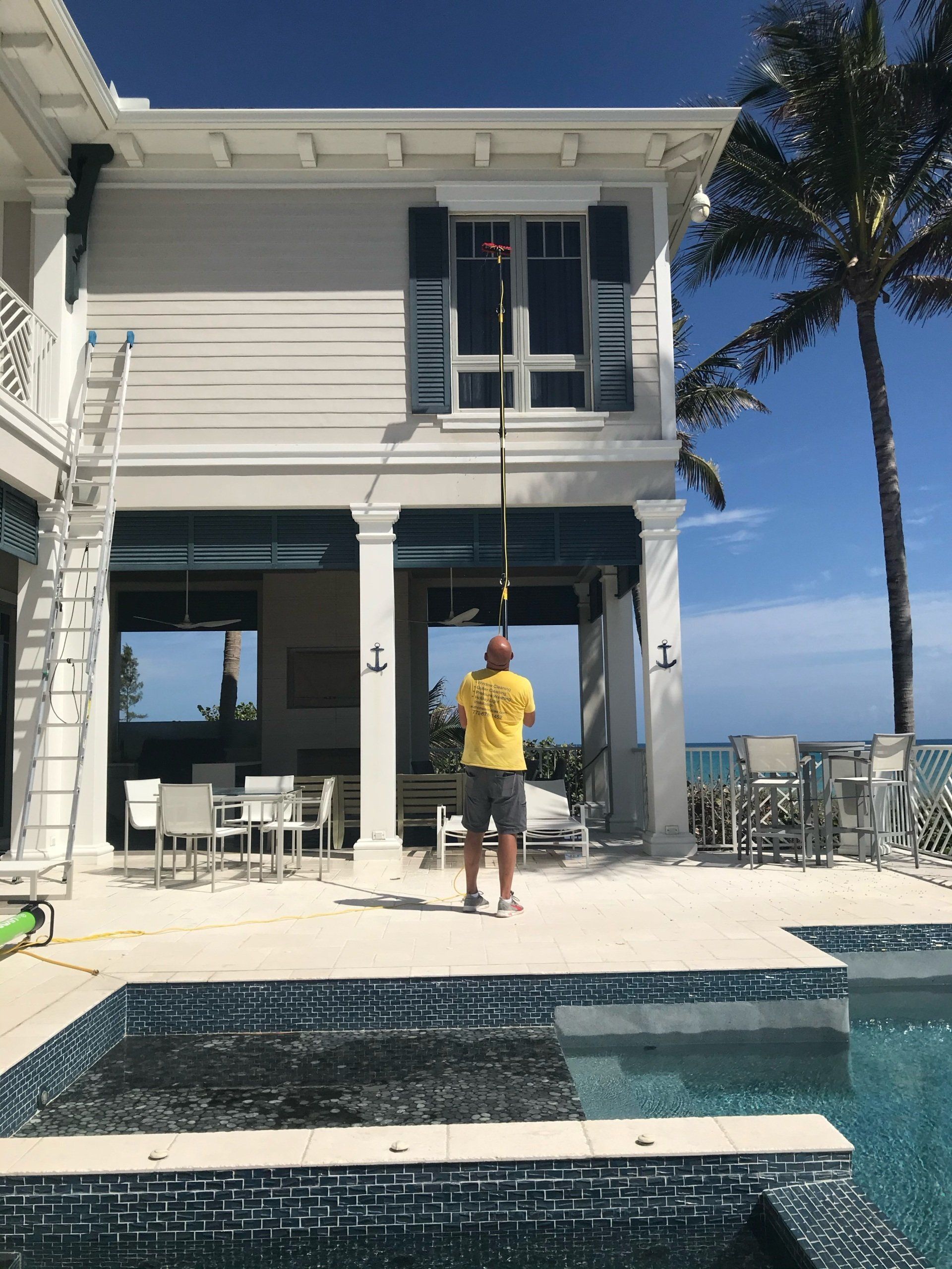 Worker cleaning a window