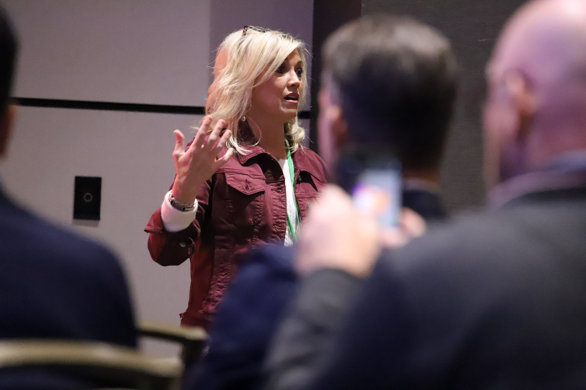 A woman is giving a presentation to a group of people.