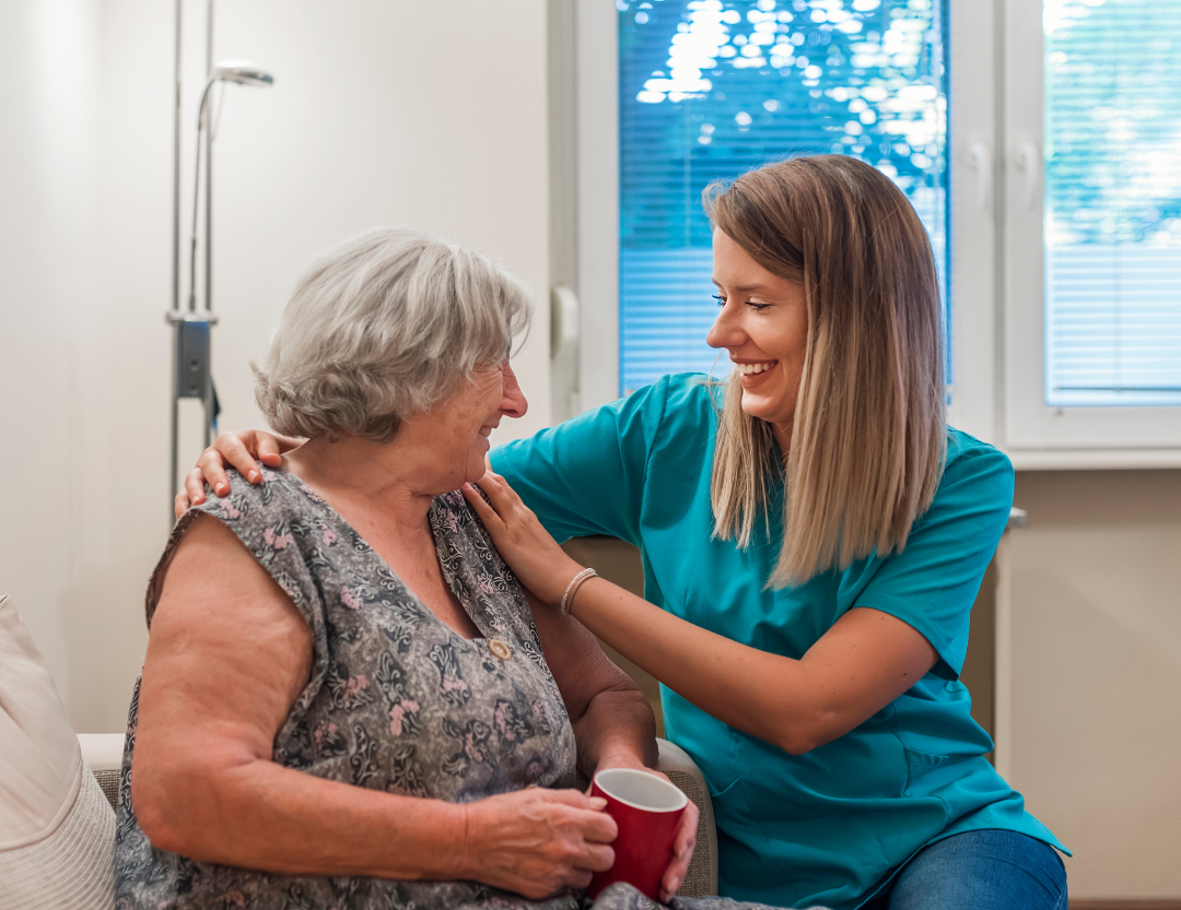 A caregiver and senior client enjoying a conversation.