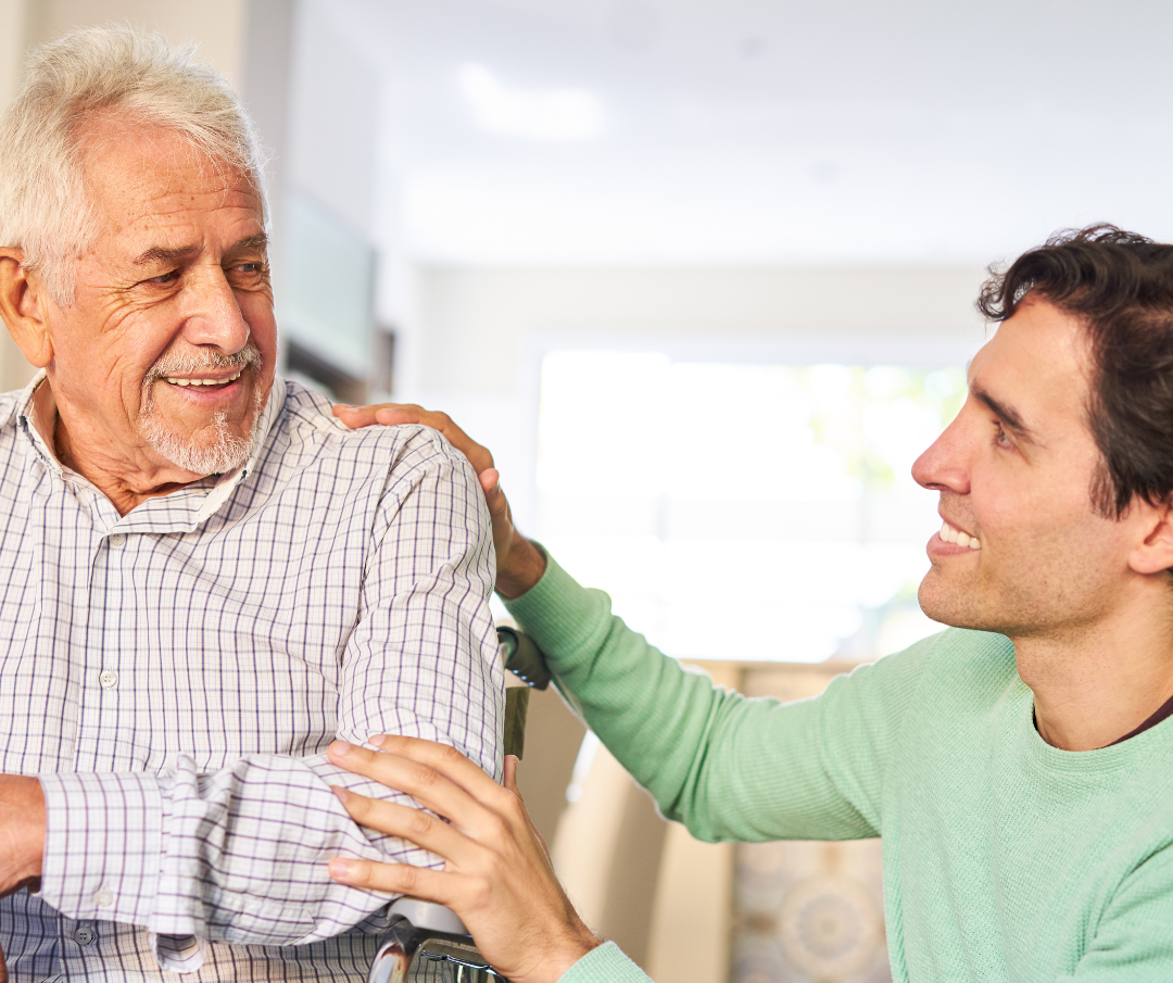 A caregiver and senior client smiling together.
