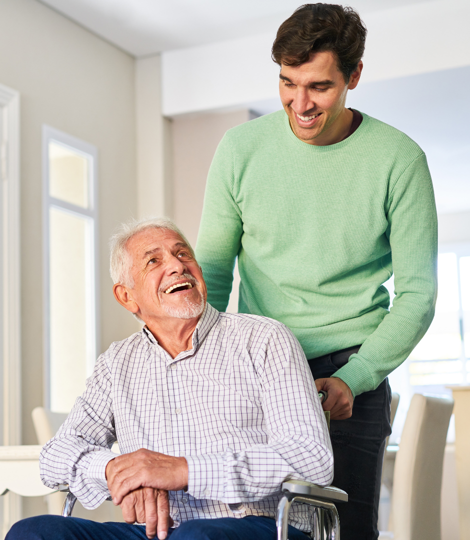 Caregiver assisting senior man in a wheelchair.