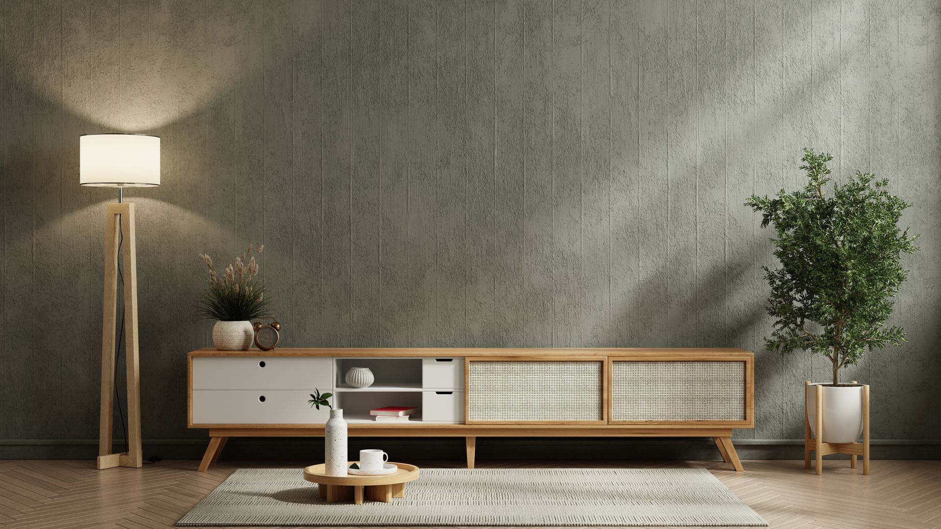 Un soggiorno con un muro di cemento, un mobile porta TV in legno, una lampada e un tappeto.